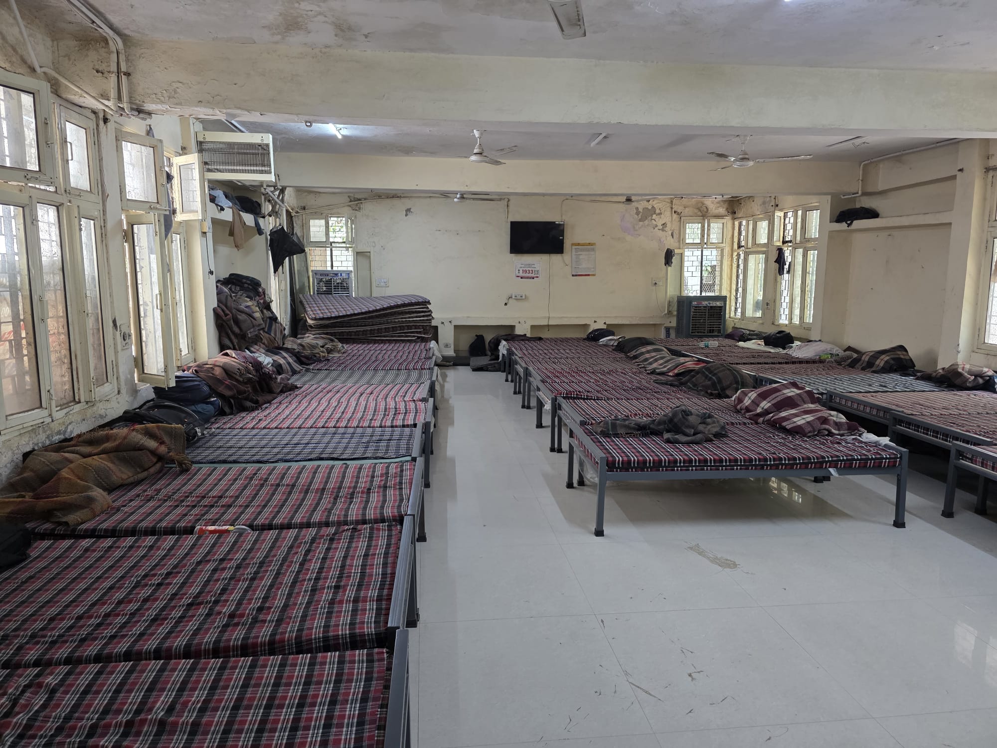 Dormitory room with rows of beds in a shelter facility